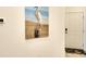 Hallway view of heron art print on wall, and a doorway with welcome mat at 5433 Mystic Water Cv, Lakewood Ranch, FL 34211