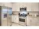 A contemporary kitchen with stainless steel appliances and white shaker cabinets at 5433 Mystic Water Cv, Lakewood Ranch, FL 34211