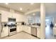 Modern kitchen featuring stainless steel appliances, white cabinets and granite countertops at 5433 Mystic Water Cv, Lakewood Ranch, FL 34211