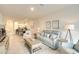 Open concept living room showcasing modern finishes, neutral color palette, and seamless flow into the adjacent kitchen at 5433 Mystic Water Cv, Lakewood Ranch, FL 34211
