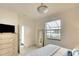 Sunlit main bedroom with modern furnishings, neutral colors, carpet and a window with views of a pond at 5433 Mystic Water Cv, Lakewood Ranch, FL 34211