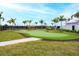 Putting green features a well-maintained artificial turf and lush landscaping at 5433 Mystic Water Cv, Lakewood Ranch, FL 34211