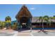 Charming entrance to a tropical-themed restaurant featuring thatched roofs and outdoor seating at 5448 Avenida Del Mare, Sarasota, FL 34242