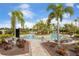 Relaxing community pool with lush greenery and comfortable lounge chairs, perfect for enjoying the sunny weather at 5469 Lampiasi St, Sarasota, FL 34238