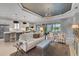 Bright and airy living room with modern lighting, neutral tones, and access to outdoor space at 5469 Lampiasi St, Sarasota, FL 34238