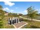 Outdoor chess area with large chess pieces, a walking path, and a view of the pond and surrounding landscape at 5469 Lampiasi St, Sarasota, FL 34238