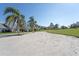 Exterior view of the homes, showing landscaping and grassy areas at 5556 Country Club Way # 5556, Sarasota, FL 34243