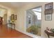 Hallway featuring a unique atrium with plants and natural light, enhancing the home's serene atmosphere at 5556 Country Club Way # 5556, Sarasota, FL 34243