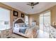 Spacious main bedroom featuring tray ceilings, tile floors, and large windows at 5663 Country Walk Ln, Sarasota, FL 34233