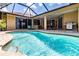 Screened-in pool area with pristine pool and covered patio seating at 5663 Country Walk Ln, Sarasota, FL 34233