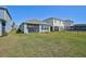 A spacious backyard featuring a well-maintained lawn and screened-in patio, perfect for outdoor relaxation and entertainment at 5675 Equator Ct, Nokomis, FL 34275