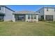 A well-maintained backyard offers a tranquil outdoor space with lush green grass and a partially screened patio at 5675 Equator Ct, Nokomis, FL 34275