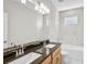 Bright bathroom features double sinks, granite countertop, tub and stylish marble tiling at 5675 Equator Ct, Nokomis, FL 34275