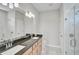 Beautiful bathroom with granite countertop, double sink, and walk-in glass shower at 5675 Equator Ct, Nokomis, FL 34275