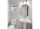 Bathroom featuring a pedestal sink, modern mirror, and a neutral color scheme at 5675 Equator Ct, Nokomis, FL 34275