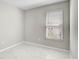 Neutral bedroom with marble tile and a window that provides natural light at 5675 Equator Ct, Nokomis, FL 34275