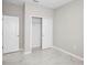 An airy bedroom featuring marble floors and closet with double doors that offers ample storage space at 5675 Equator Ct, Nokomis, FL 34275