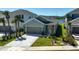 Charming single-story home with a well-manicured lawn, a two-car garage, and lush landscaping enhancing curb appeal at 5675 Equator Ct, Nokomis, FL 34275