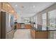 A modern kitchen boasts stainless steel appliances, granite countertops, and lots of natural light at 5675 Equator Ct, Nokomis, FL 34275