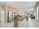Modern kitchen featuring stainless steel appliances, granite countertops, and a spacious island at 5675 Equator Ct, Nokomis, FL 34275