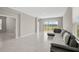 Sunlit living room boasts marble floors, and a view of the scenic lake and neighborhood at 5675 Equator Ct, Nokomis, FL 34275