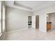 Spacious main bedroom with marble flooring, tray ceiling, and ensuite bathroom entrance at 5675 Equator Ct, Nokomis, FL 34275