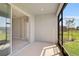 Relaxing patio with views of a neatly kept lawn, neighborhood homes, and lush trees at 5675 Equator Ct, Nokomis, FL 34275