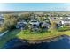 Aerial view of backyard with pool, screened-in lanai and waterfront views at 5709 Sunflower Cir, Sarasota, FL 34238