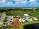 Aerial view of the community, featuring a pool, playground, basketball court, and lush greenery at 5709 Sunflower Cir, Sarasota, FL 34238
