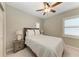 Comfortable bedroom with a ceiling fan and natural light from shuttered windows at 5709 Sunflower Cir, Sarasota, FL 34238