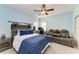 A bedroom with blue walls and a mounted sword rack above the bed, also featuring a seating area at 5709 Sunflower Cir, Sarasota, FL 34238