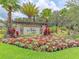 Inviting community entrance sign surrounded by colorful flowers and lush landscaping at 5709 Sunflower Cir, Sarasota, FL 34238