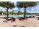 A spacious community pool surrounded by lounge chairs and lush landscaping at 5709 Sunflower Cir, Sarasota, FL 34238