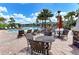 Relaxing community pool area featuring comfortable lounge chairs, tables, and lush tropical landscaping at 5709 Sunflower Cir, Sarasota, FL 34238