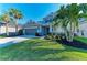 Two-story home with a gray facade, well-manicured lawn, and a two-car garage at 5709 Sunflower Cir, Sarasota, FL 34238