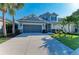 Two-story home with a gray facade, well-manicured lawn, and a two-car garage at 5709 Sunflower Cir, Sarasota, FL 34238