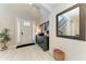 Bright foyer with light hardwood floors, staircase and console table at 5709 Sunflower Cir, Sarasota, FL 34238