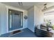 Inviting front porch with seating area and a stylish front door at 5709 Sunflower Cir, Sarasota, FL 34238