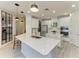 Spacious white kitchen with stainless steel appliances, quartz countertops, and ample cabinet space at 5709 Sunflower Cir, Sarasota, FL 34238