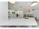 Bright kitchen boasting white cabinetry, stainless steel appliances, and a quartz countertop island at 5709 Sunflower Cir, Sarasota, FL 34238