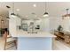 Modern kitchen featuring a large island, stainless steel appliances, and an adjacent dining area at 5709 Sunflower Cir, Sarasota, FL 34238