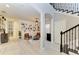 Open-concept living room with a built-in bookshelf, modern furnishings, and hardwood floors at 5709 Sunflower Cir, Sarasota, FL 34238