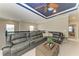 Second floor living room with a custom ceiling, comfortable seating, and an open layout at 5709 Sunflower Cir, Sarasota, FL 34238