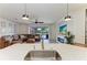 Open-concept space with island sink view to a living room and enclosed backyard pool at 5709 Sunflower Cir, Sarasota, FL 34238
