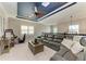 Spacious second floor living room with a custom ceiling, large sofa and natural light at 5709 Sunflower Cir, Sarasota, FL 34238