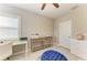 This office has a ceiling fan, a console table, and a work desk with a window view at 5709 Sunflower Cir, Sarasota, FL 34238