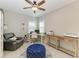 Bright office area with a ceiling fan, a leather recliner, and a work desk set up by a window at 5709 Sunflower Cir, Sarasota, FL 34238