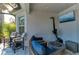 Cozy patio area with comfortable seating, a fire pit, and a mounted television for outdoor relaxation at 5709 Sunflower Cir, Sarasota, FL 34238