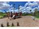Community playground featuring pirate ship play structure on wood chip base at 5709 Sunflower Cir, Sarasota, FL 34238