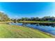 Scenic view of a pond surrounded by lush greenery, showcasing the community's natural beauty and serene setting at 5709 Sunflower Cir, Sarasota, FL 34238